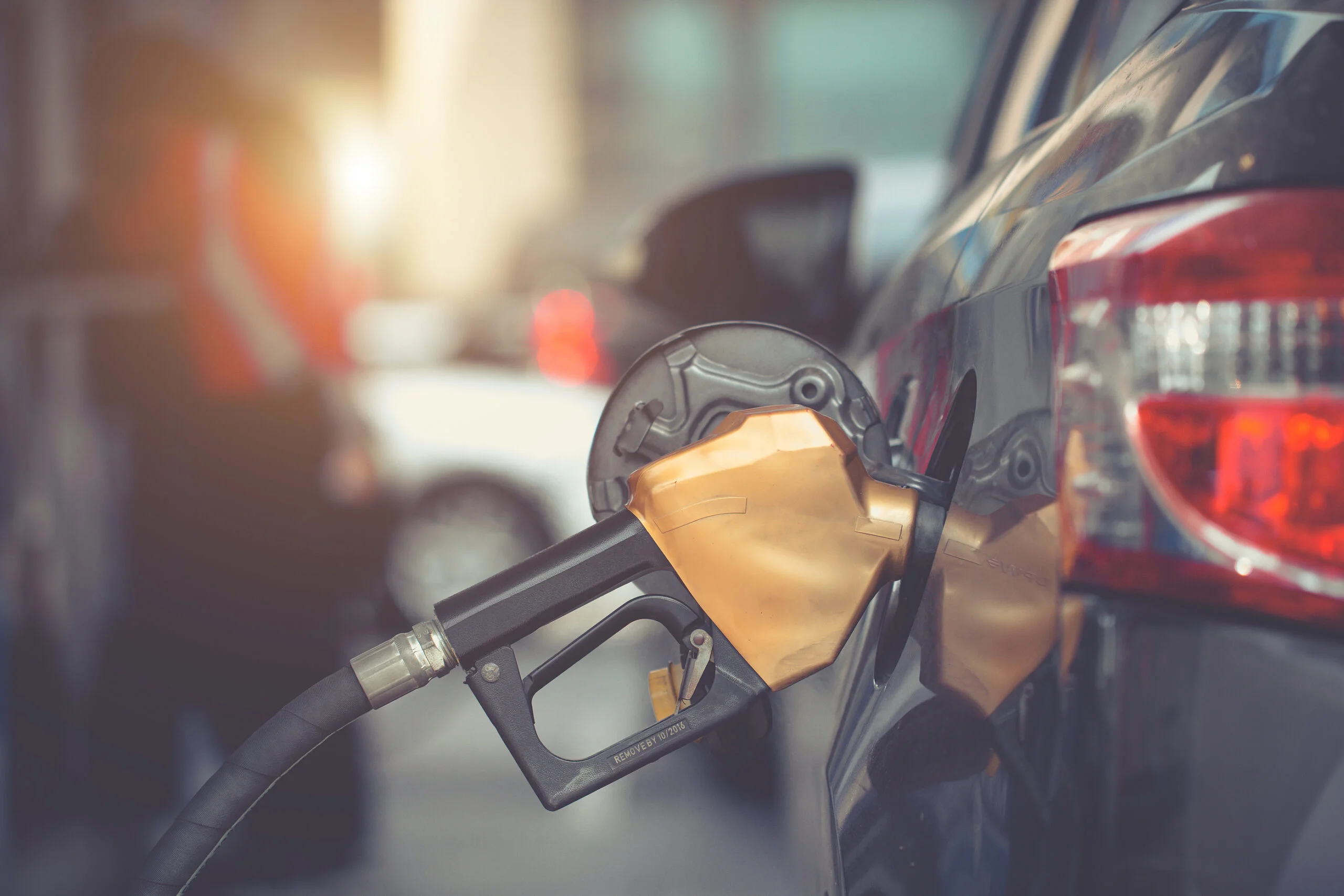 gas vs diesel cars. image of a gold gas pump in a car pumping gas.